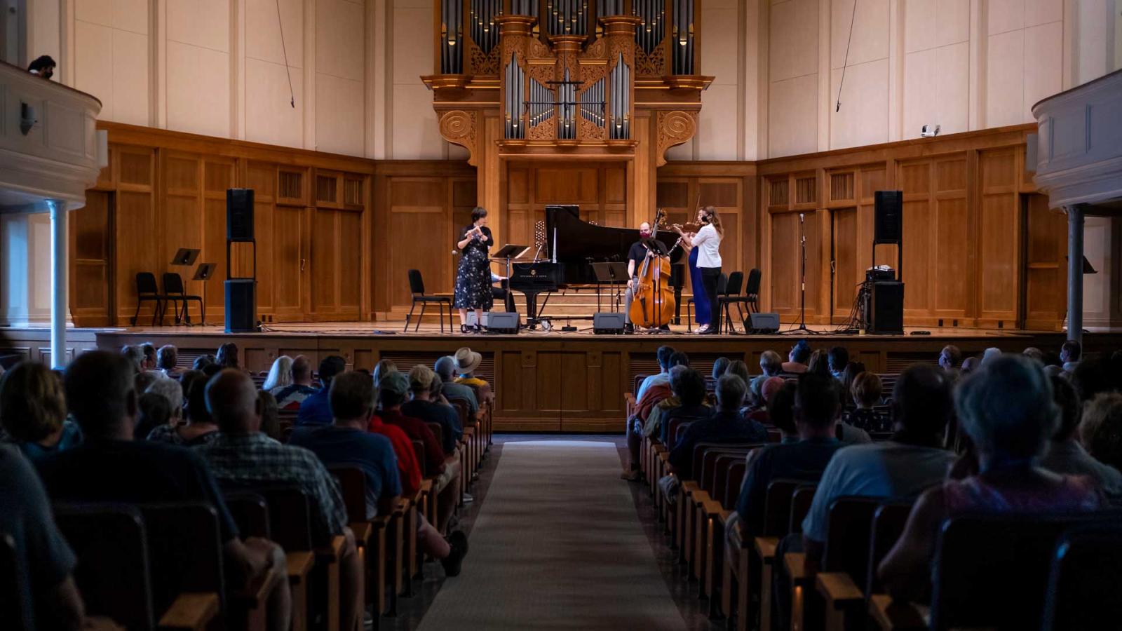 Decoda and Adriel Denae perform in front of a full audience on stage in Memorial Chapel.