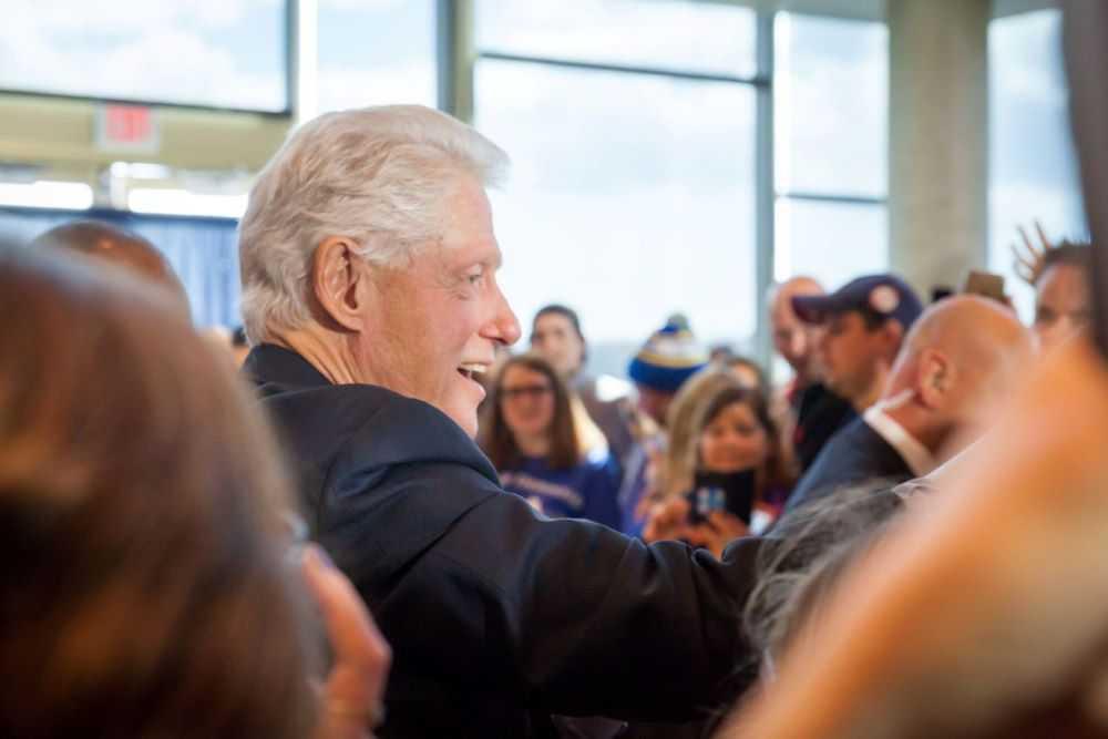 Bill Clinton shakes hands as he works through a crowd in Warch Campus Center.