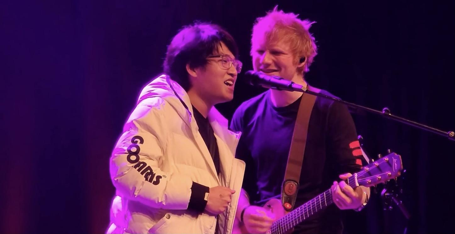 Michael Zhang sings at the microphone with Ed Sheeran