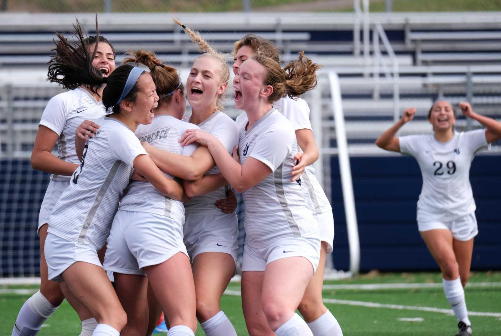 Lawrence women's soccer players embrace following the win that put them into the conference tournament.