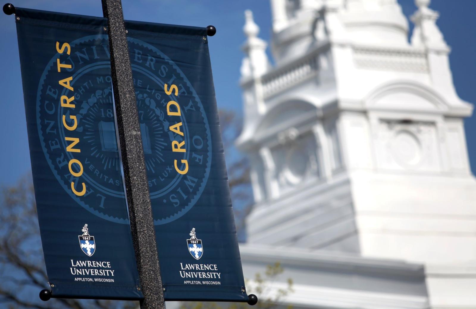 Banners reading Congrats Grads hang on light poles along College Avenue.