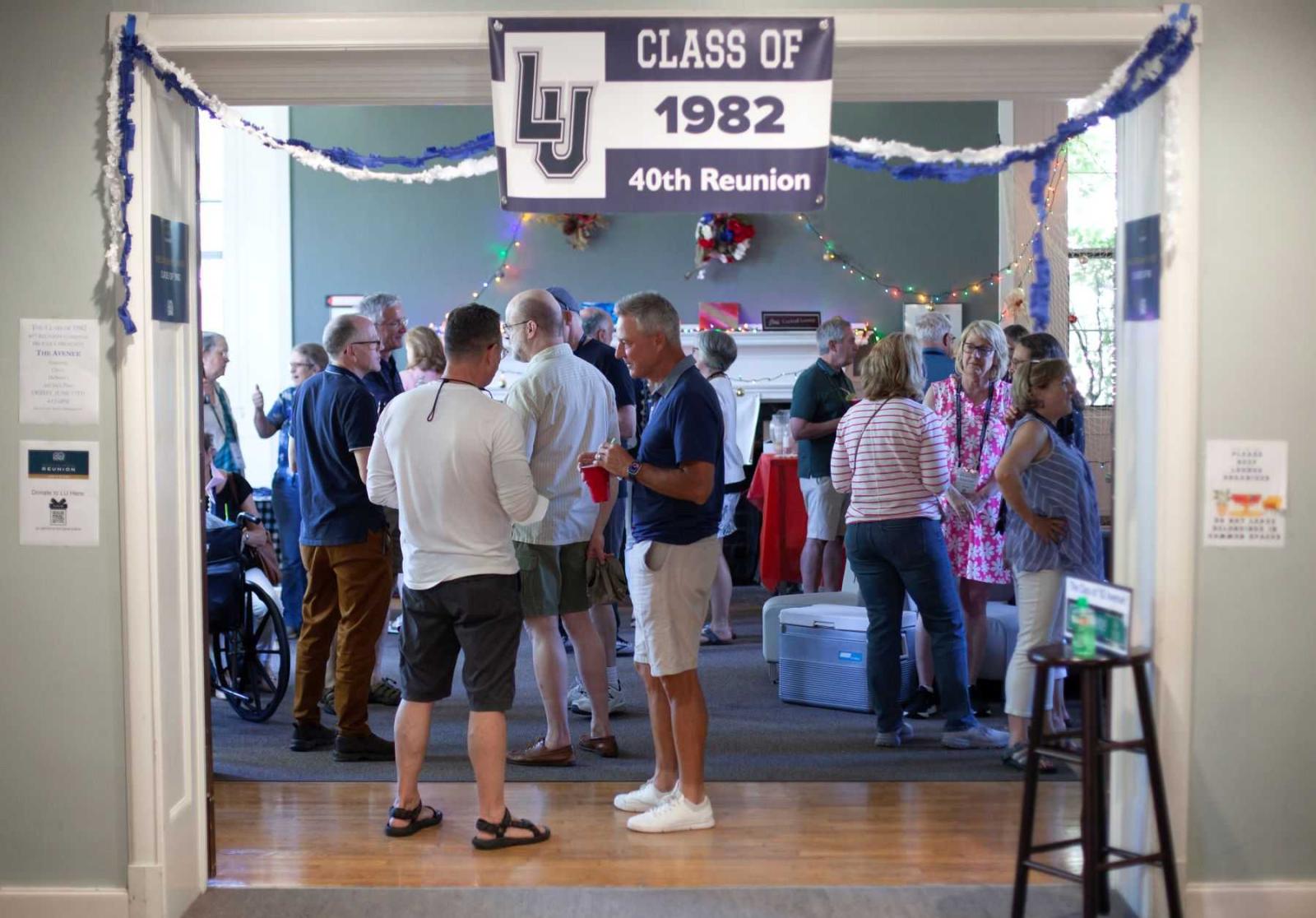Members of the Class of 1982 socialize in the lobby of Sage Hall.