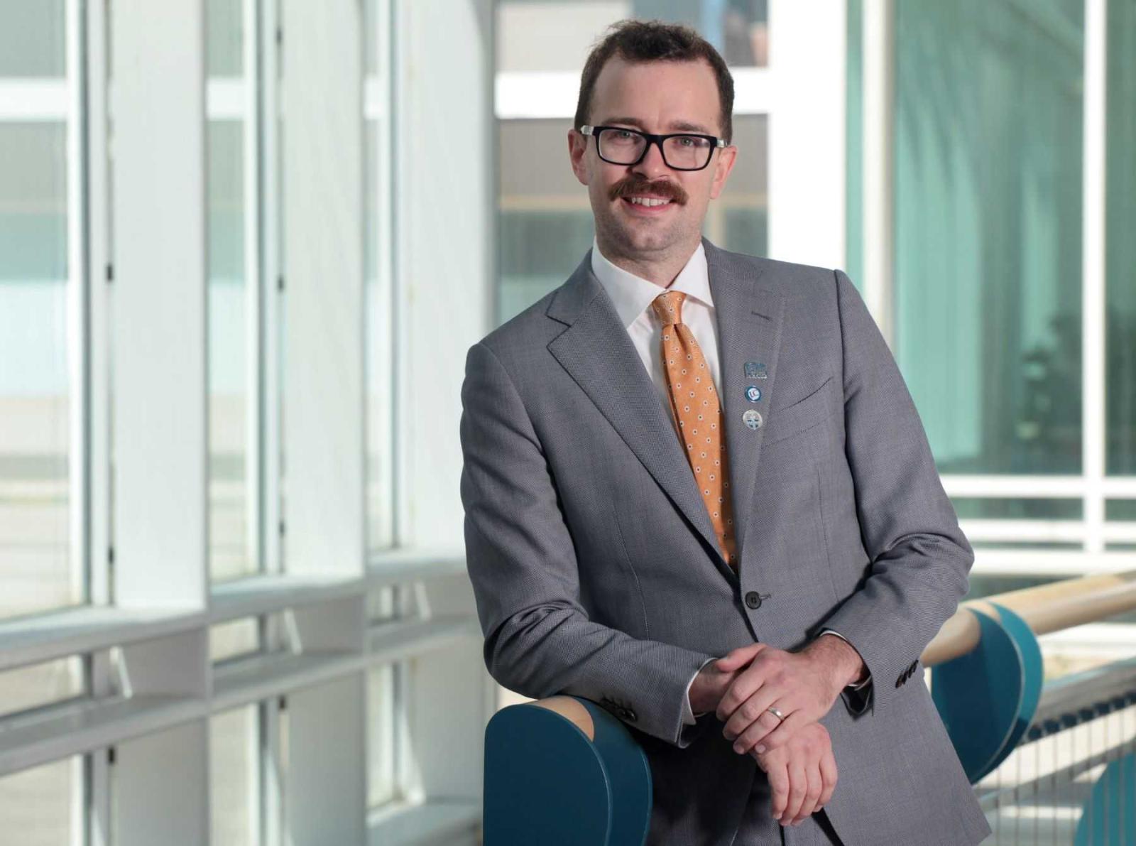 Matt Murphy, dressed in a suit and tie, poses for a portrait during Reunion weekend.