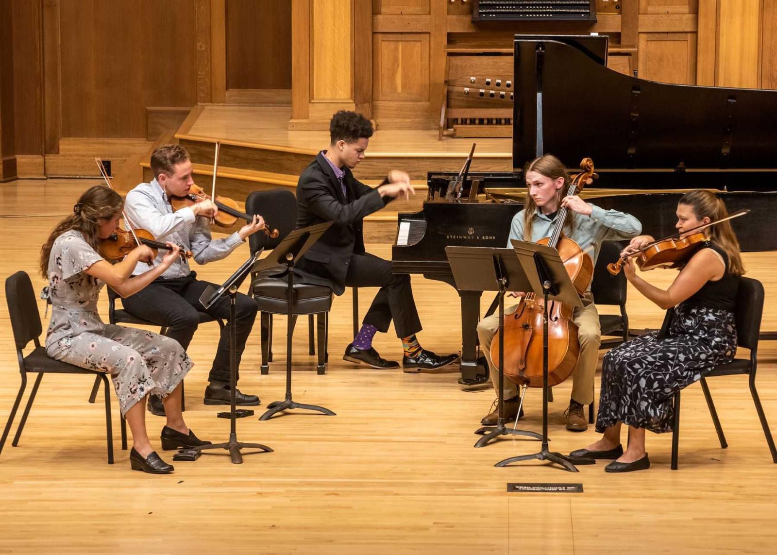 Students taking part in the Decoda Chamber Music Festival perform on the Memorial Chapel stage.