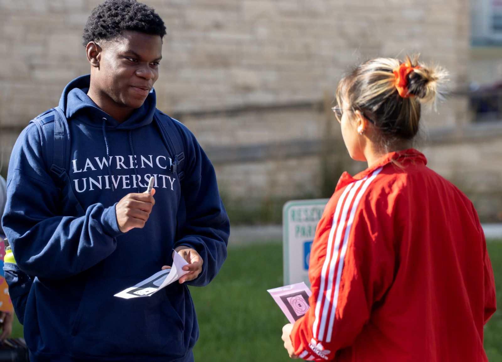 Micheal Greenland, a first-year student, talks with a CA during New Student Move-in. 
