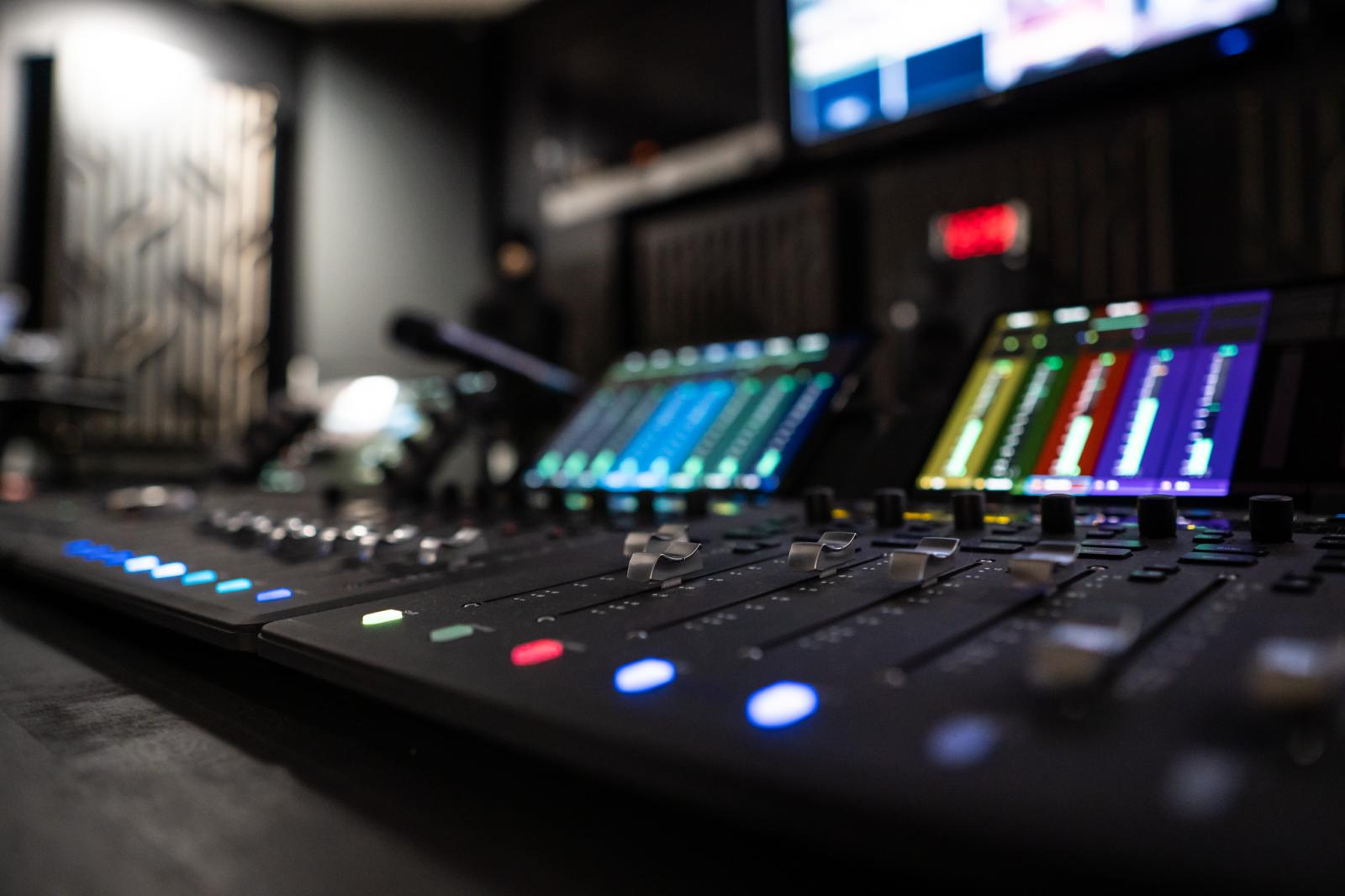 Audio console with multi-colored buttons and screens.