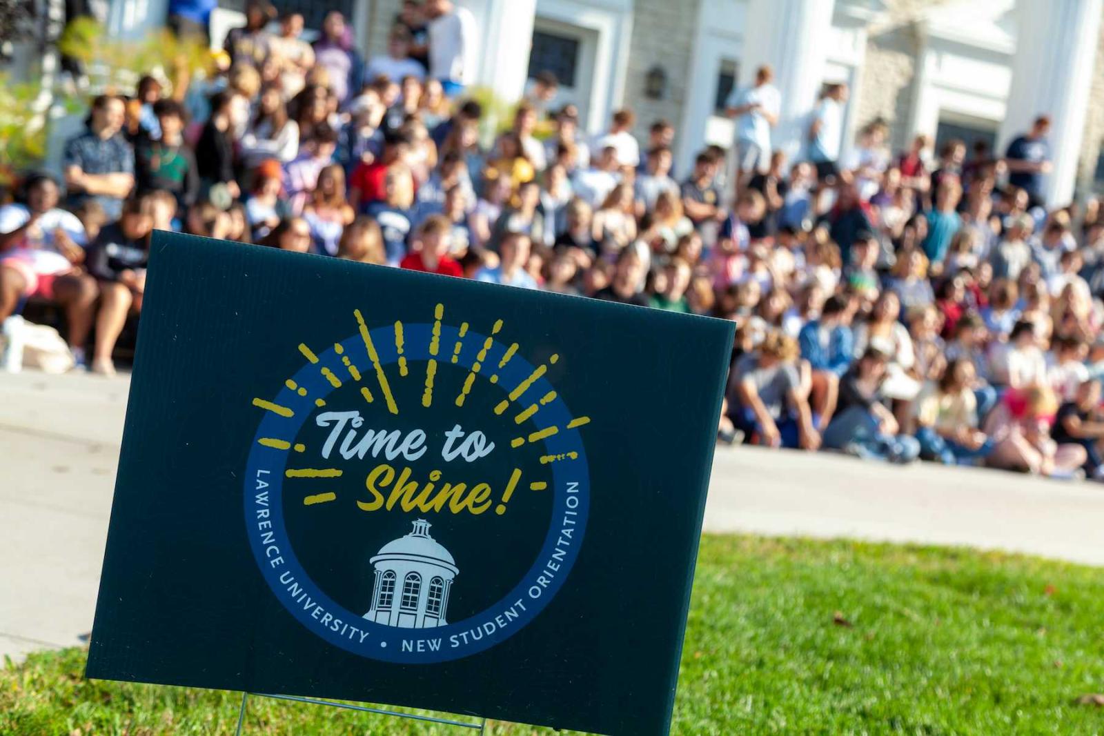 Time to Shine sign in seen on lawn in front of Memorial Chapel as the Class of 2026 lines up for a class photo during Welcome Week.