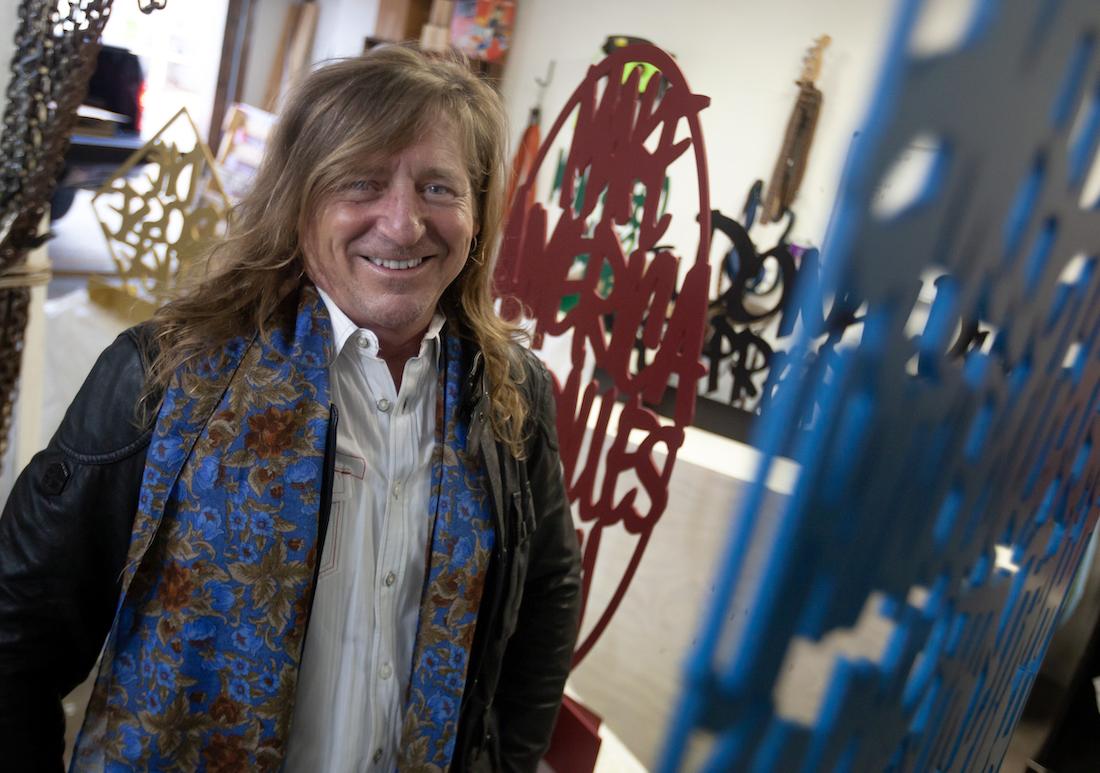 Rob Neilson stands amid artwork in his studio on campus.