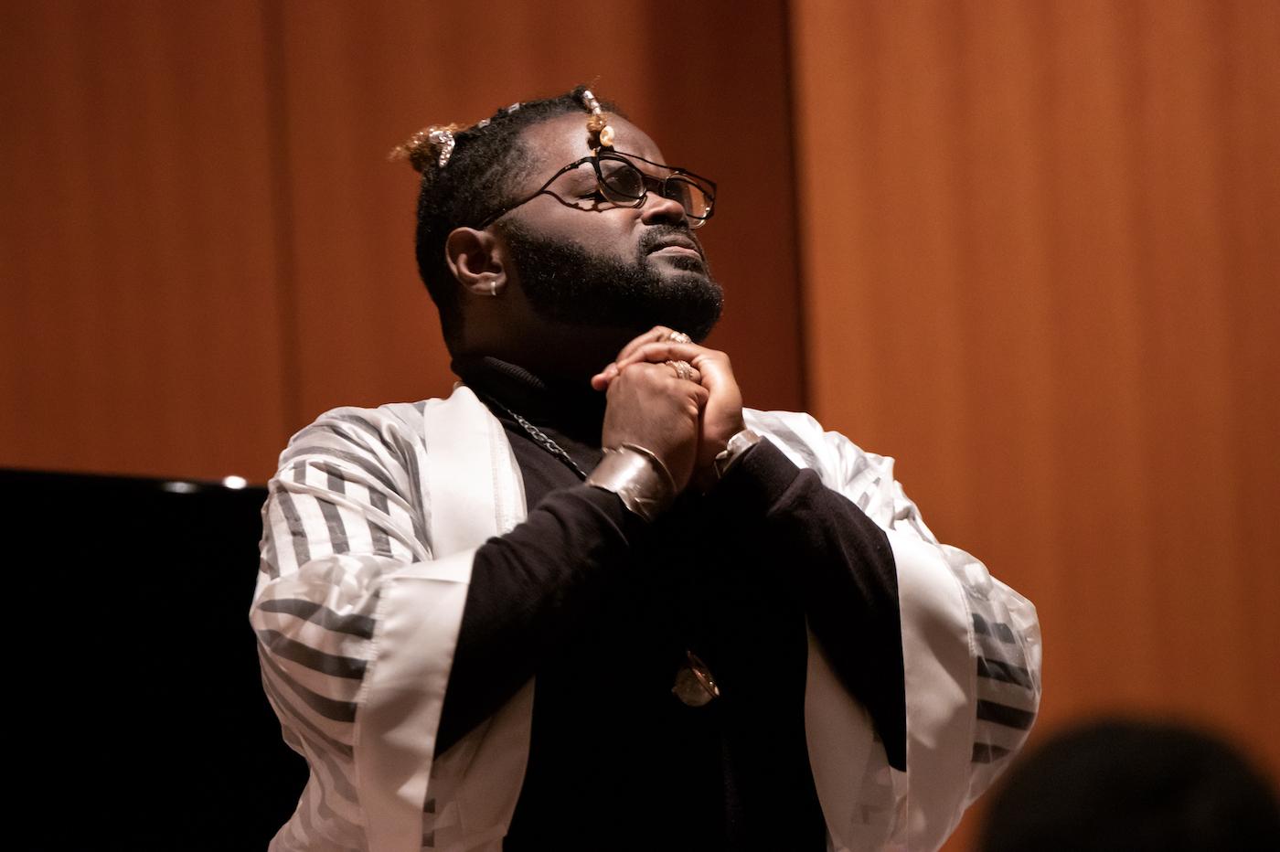 John Holiday clasps his hands as he sings during Thursday's tribute to Martin Luther King Jr.