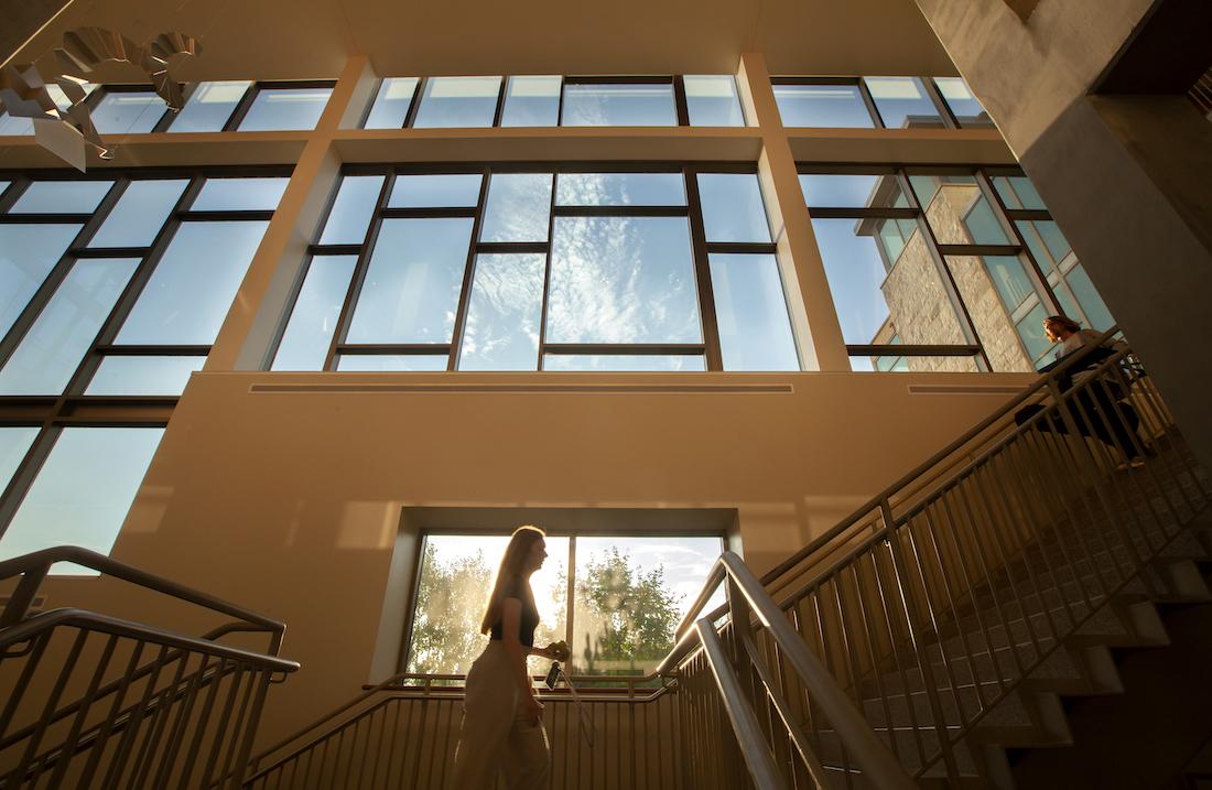 Students walk on the steps inside Warch Campus Center.