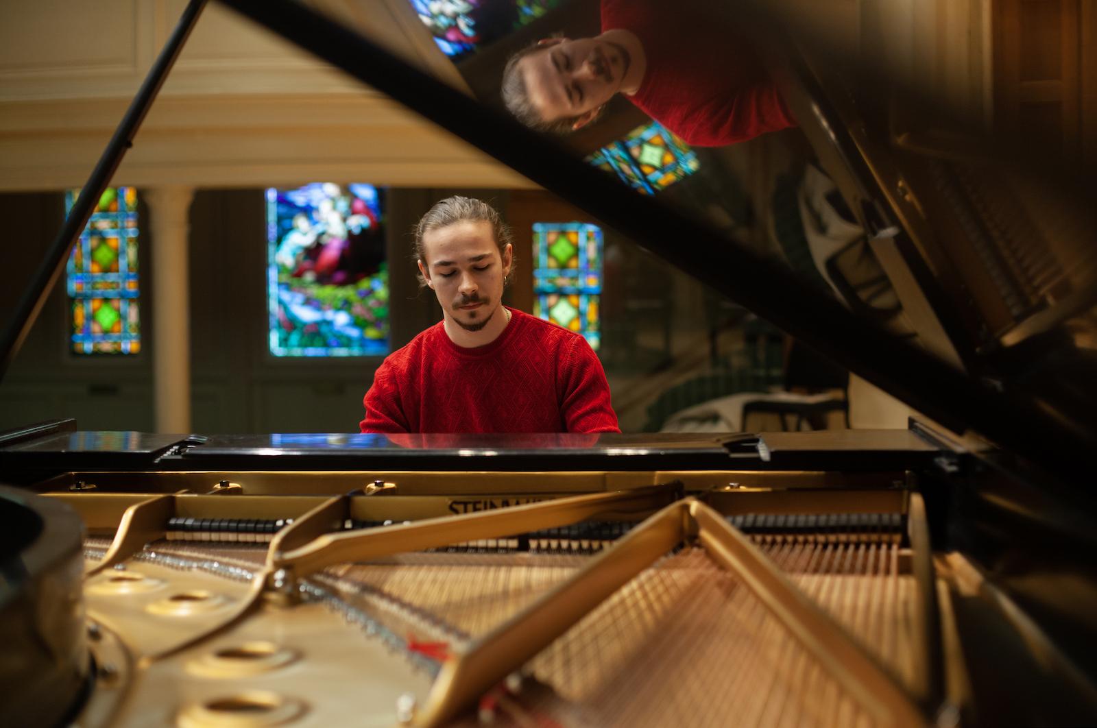 Bohdan Tataryn plays the piano on the Memorial Chapel stage.