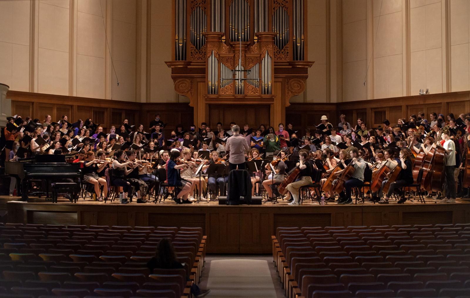 Phillip Swan leads the orchestra and choirs in a rehearsal on the Memorial Chapel stage.