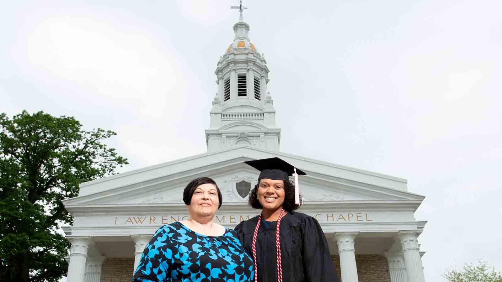 Graduate with parent in front of Lawrence Memorial Chapel