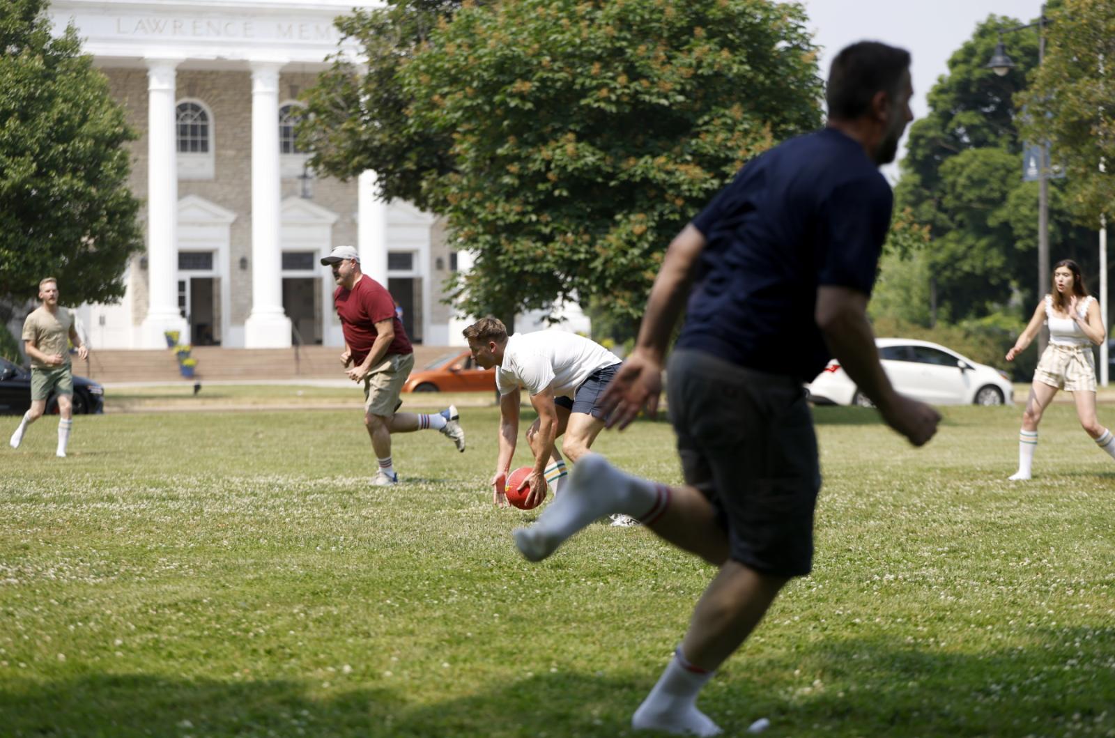 Members of the 20th and 25th reunions play kickball on Main Hall Green.
