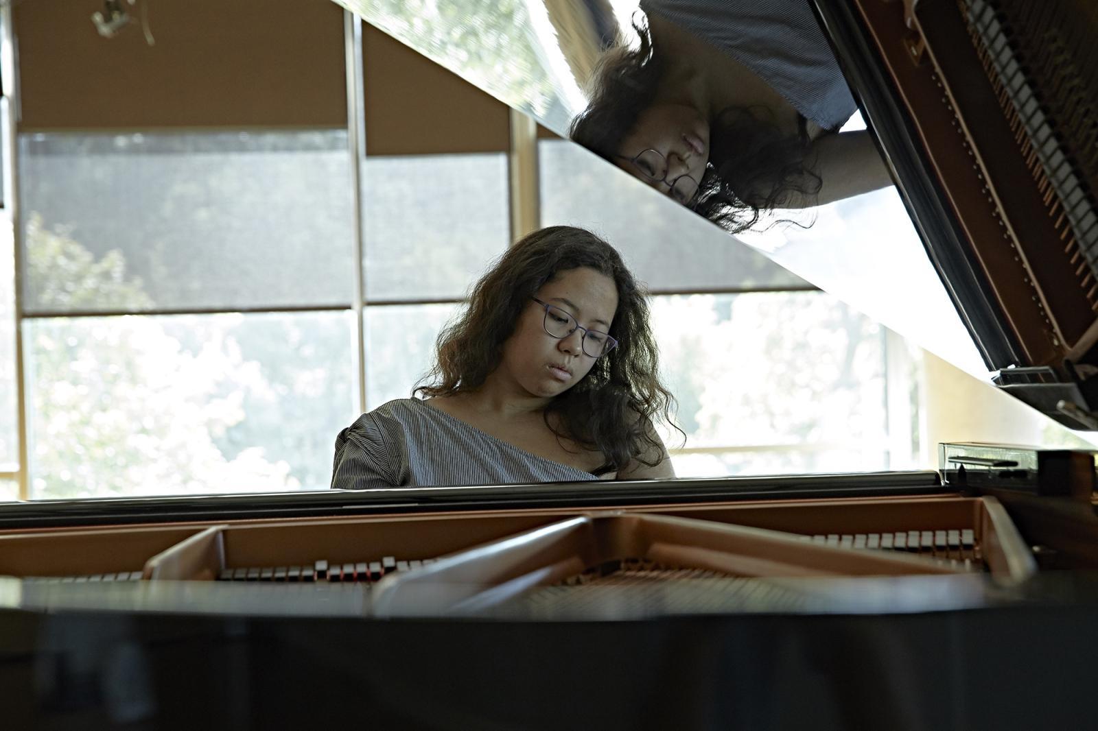 Student at piano.