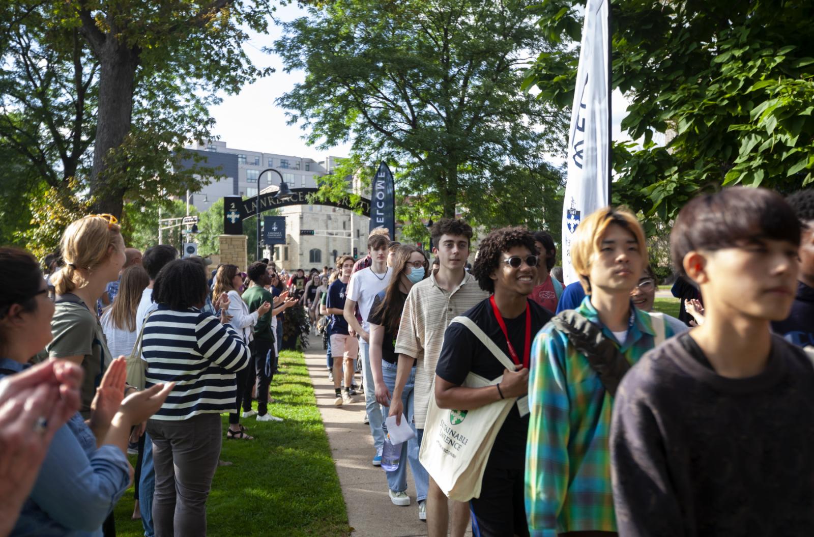 New students are greeted with applause as they process through the arch on the way to the President's Welcome in September 2022.