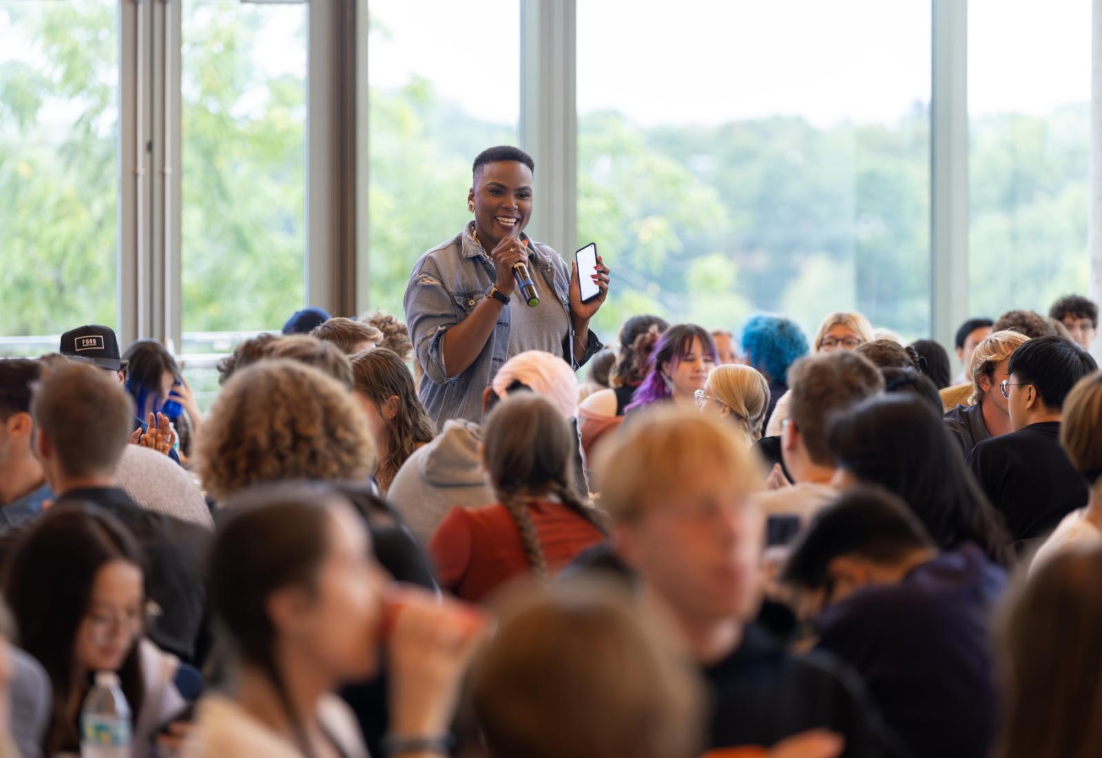 Ashley Lewis, associate vice president for enrollment, talks with a roomful of students at the annual first-year dinner.