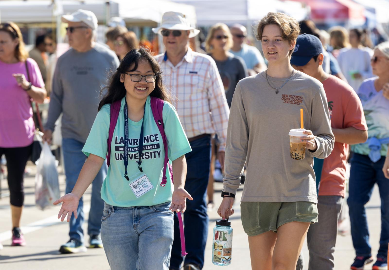 Students walk through the farmers' market in downtown Appleton.