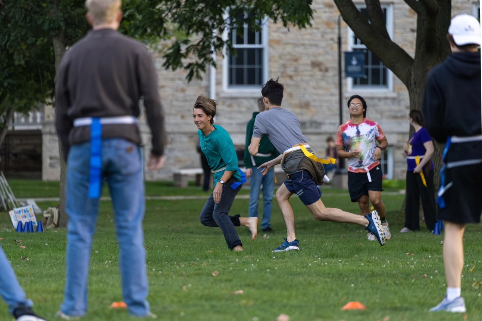 Students run on Main Hall Green while playing outdoor games.