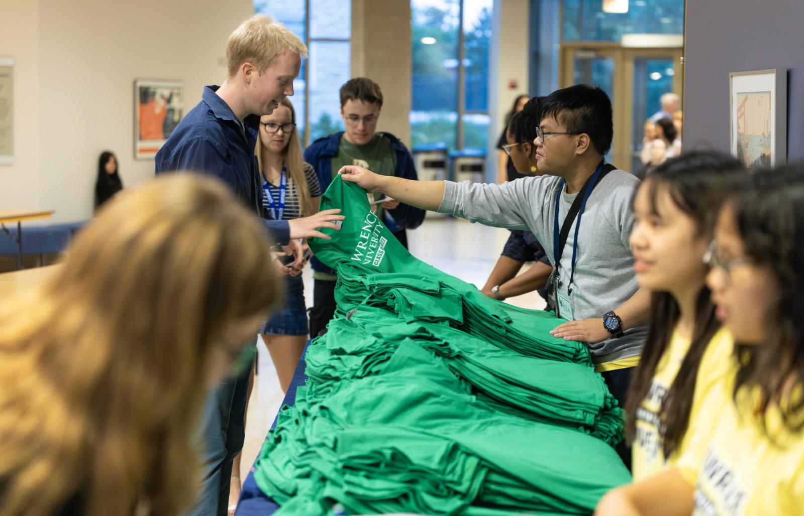 First-year students receive their Class of 2027 T-shirts.