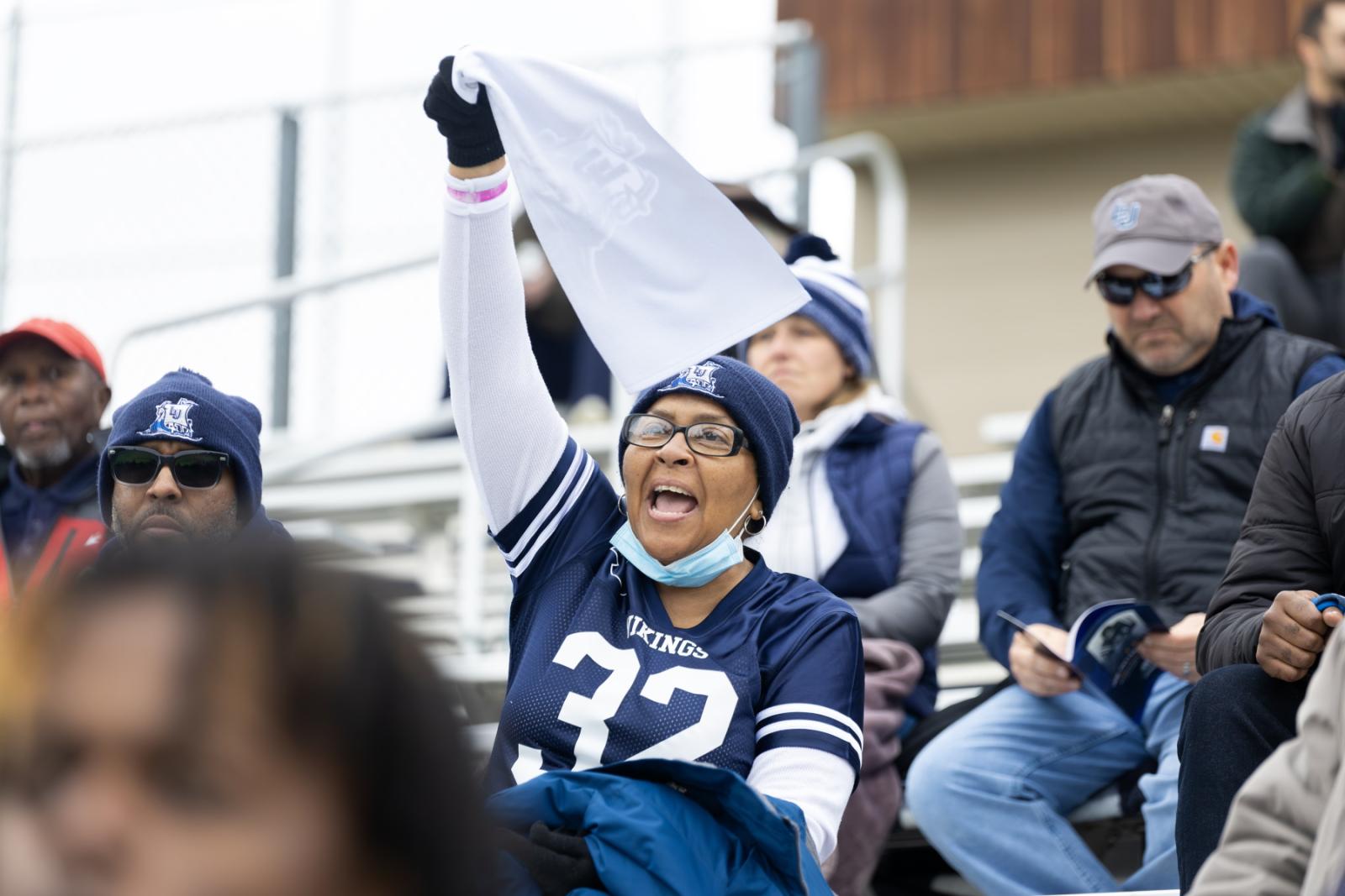 Fans cheer during the football game.
