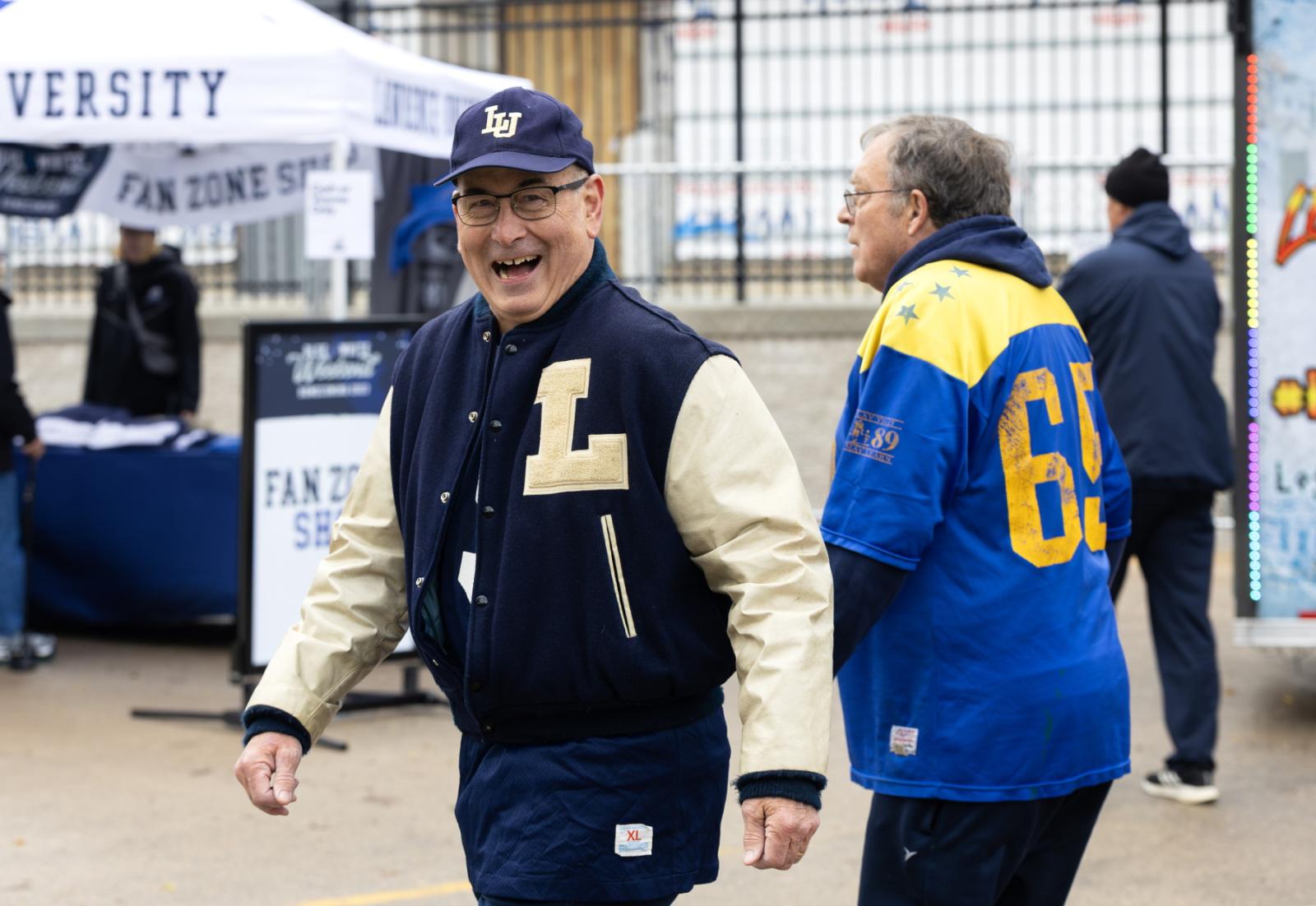 An alumnus is all smiles at the tailgate party.
