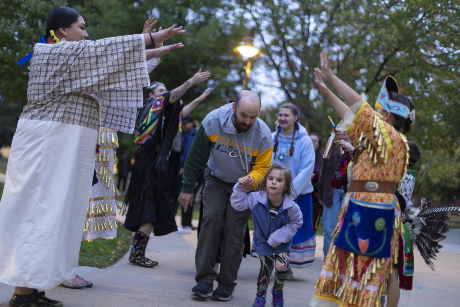 Participants walk through Main Hall Green as part of the Indigenous Peoples' Day Celebration.