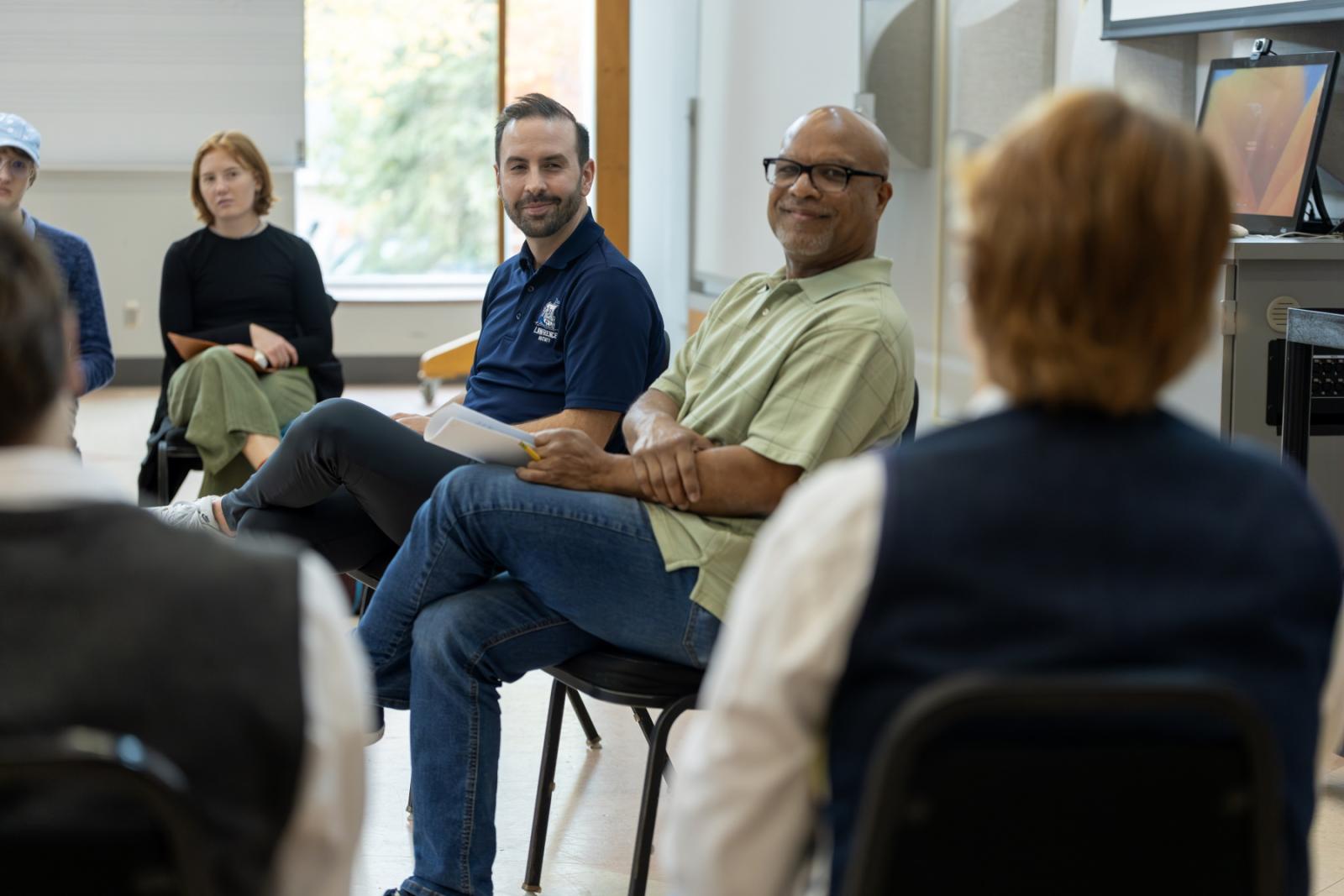 Brett Wall and José Encarnación listen as students talk about their practice experiences.