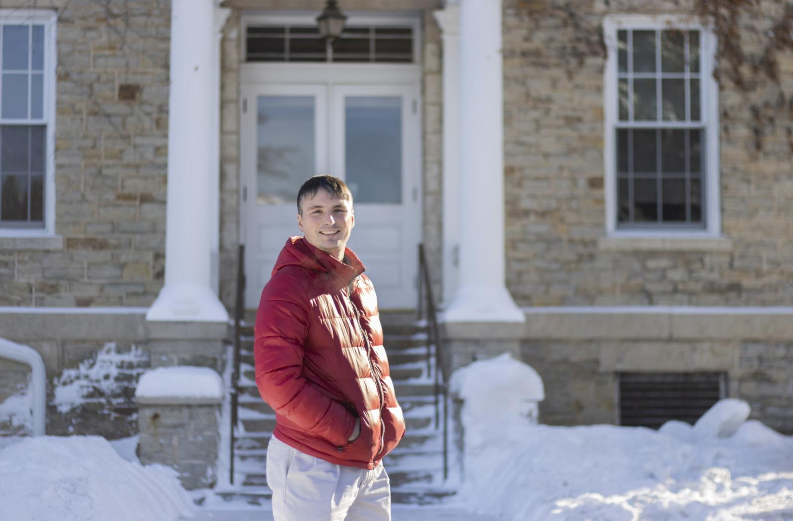 Andrew Sage poses for a photo on a snow-covered Main Hall Green.