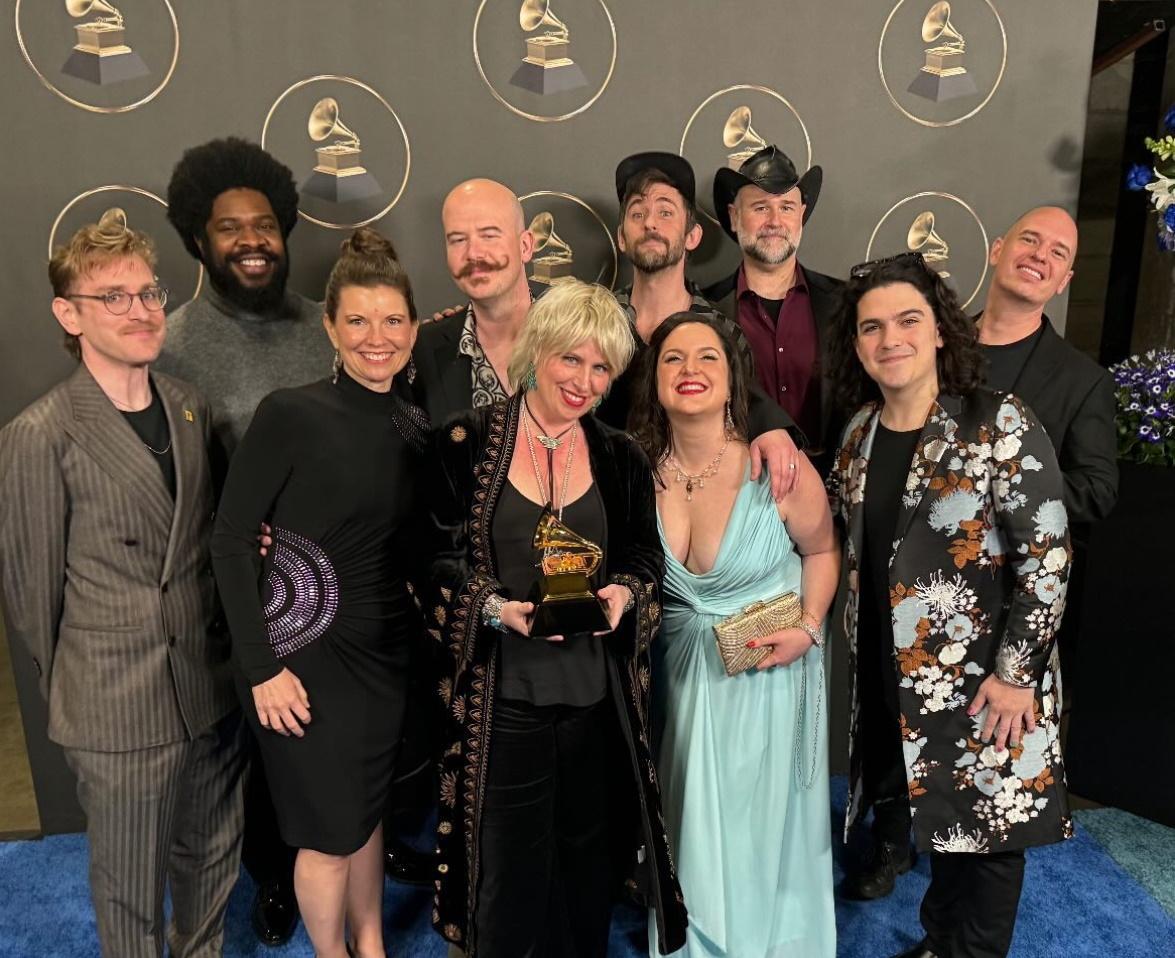 Esteli Gomez poses with her Roomful of Teeth ensemble backstage at the Grammys.