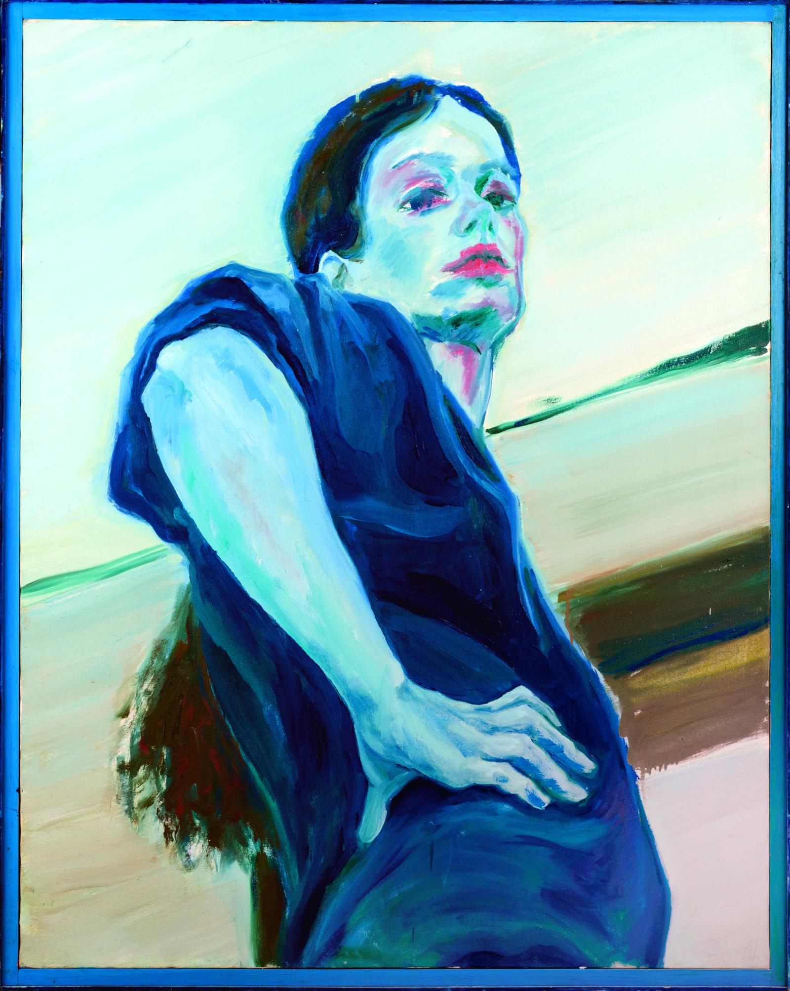 Portrait of a woman in blue shirt and long dark ponytail looking down and over her shoulder on the diagonal