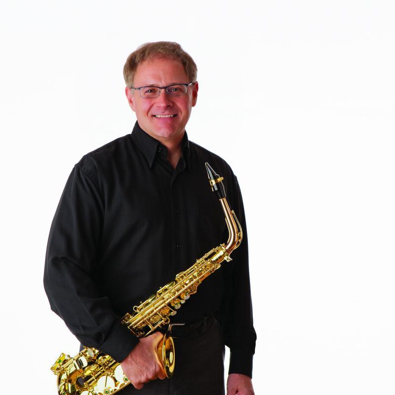 Steven Jordheim poses with a saxophone.