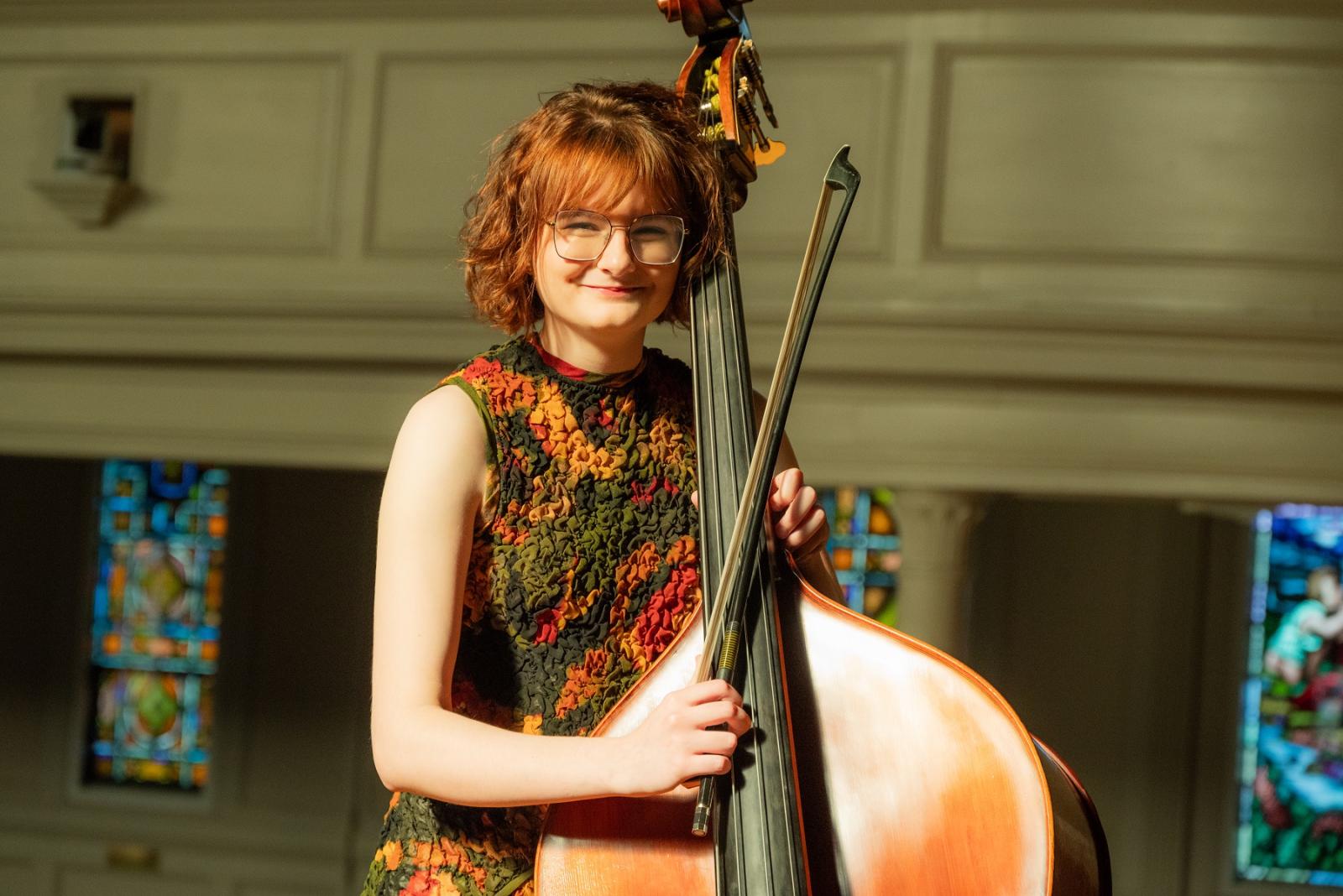 Vivian Shanley poses for a photo with her double bass.