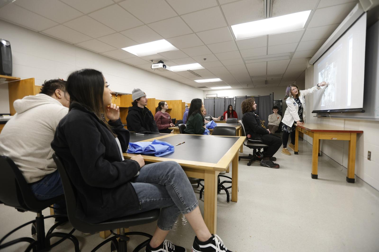 Elizabeth Becker leads a lab class that has Appleton East High School students joining her students. (Photo by Danny Damiani)