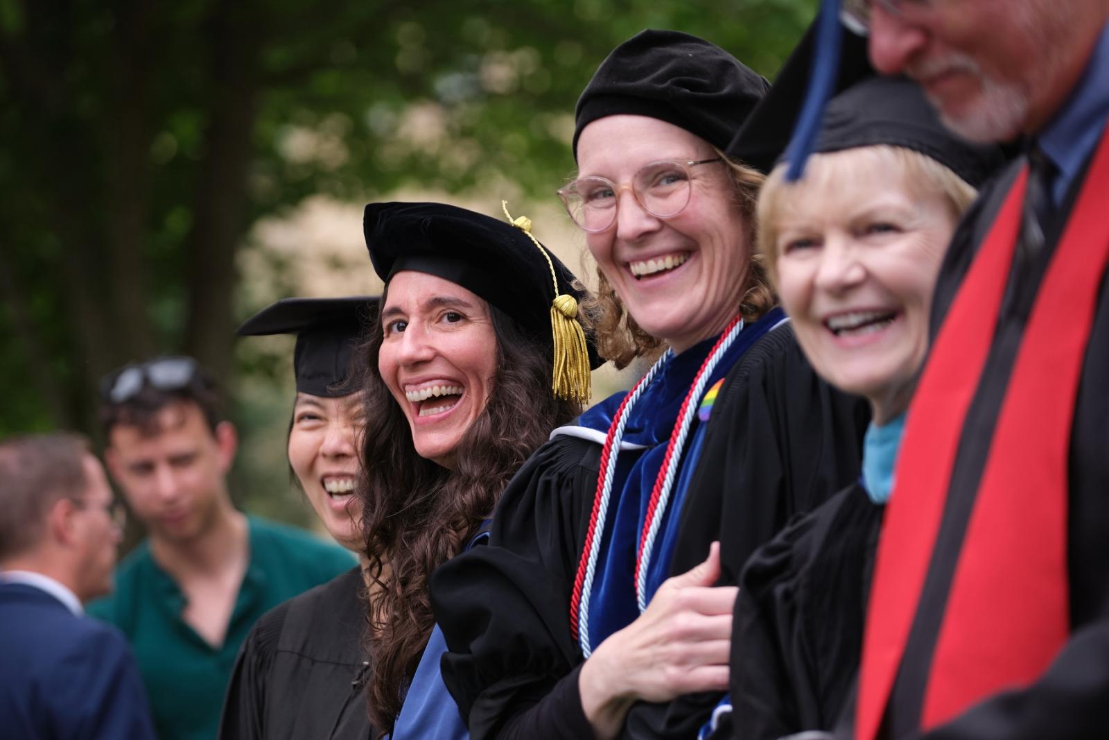 Lena Khor, Sigma Colon, and Betsy Schlabach share a laugh at Commencement.