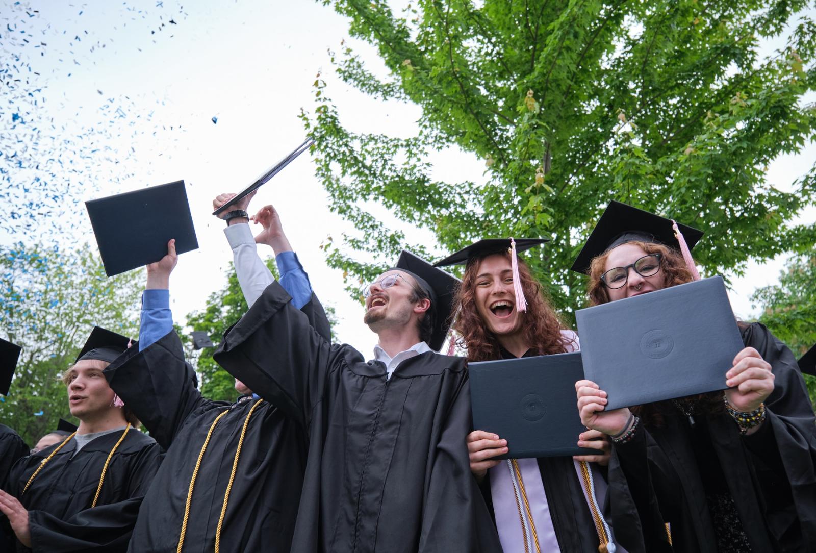 Confetti flies as Lawrence graduates cheer at the close of Commencement.