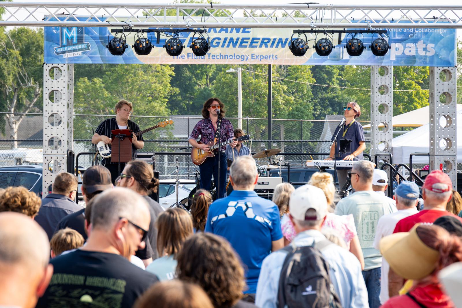 Michael Murphy performs with his band and a crowd in front 