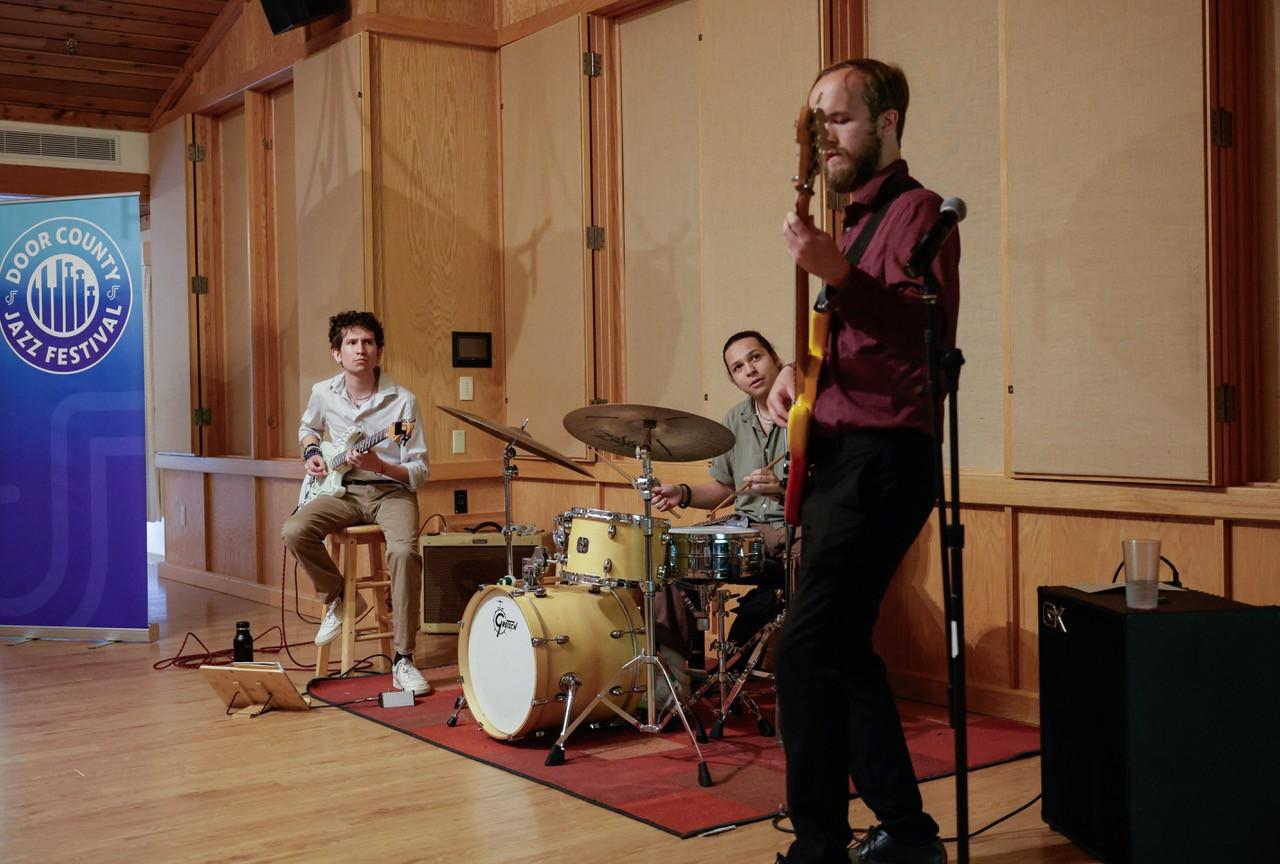 Cooper Luedke on bass, Josué Ríos López on guitar, and Quintin Fernandez on drums