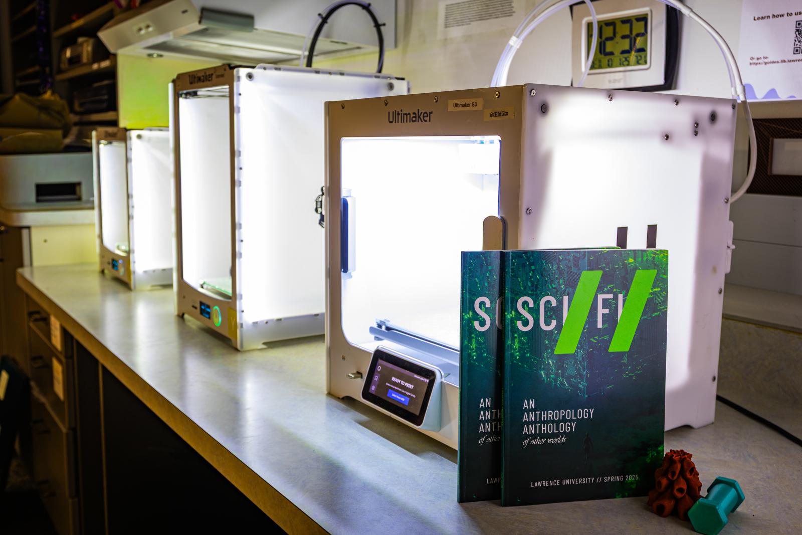 Sci Fi zines stand up against a 3D printer in the makerspace