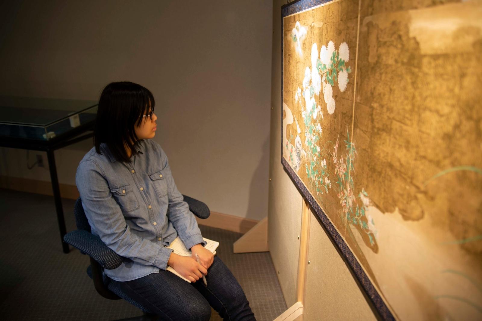 A person sitting in a chair looking at a map