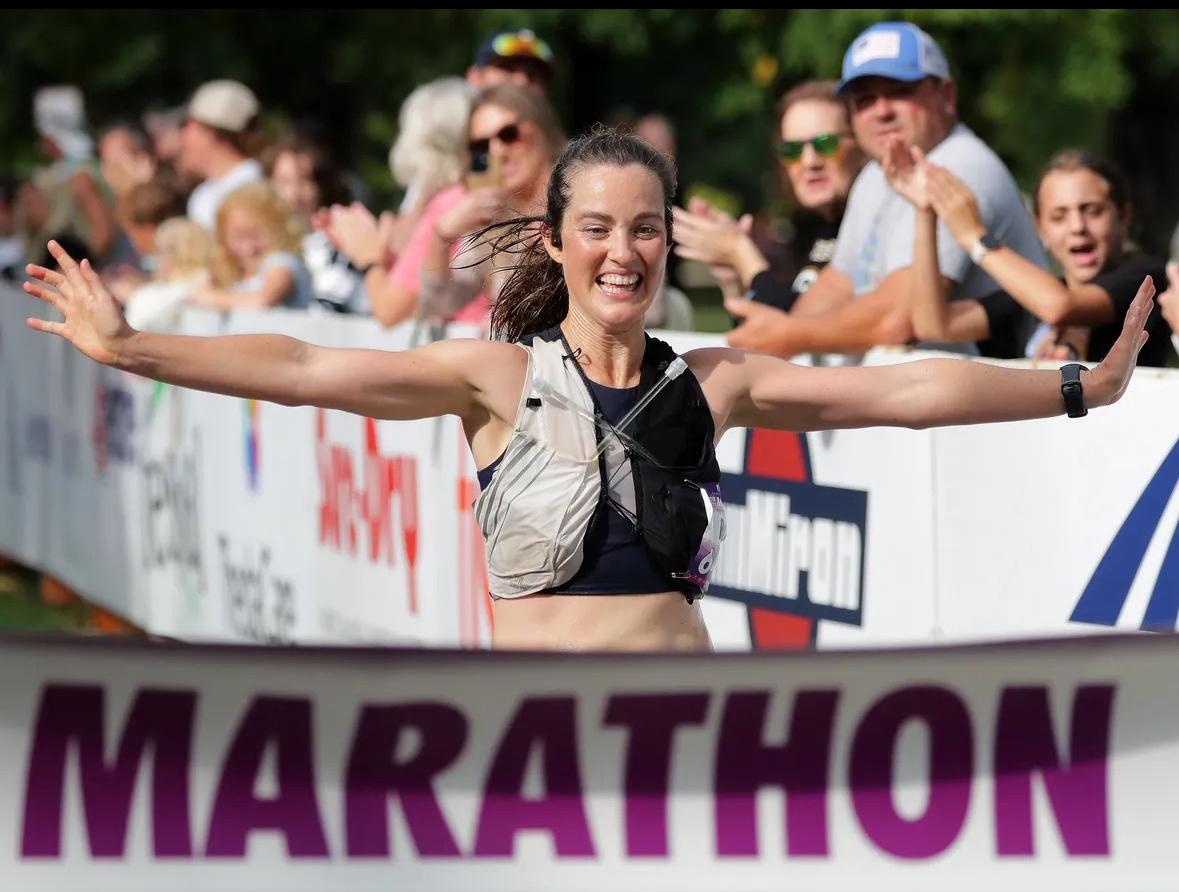 Relena Ribbons, Lawrence University's associate professor of geosciences, runs across the finsh line for victory. 