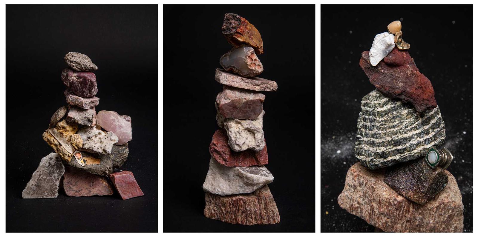 Triptych of stacked stone sculptures against a black background, featuring layered rocks, minerals, and small found objects balanced into cairn-like forms.