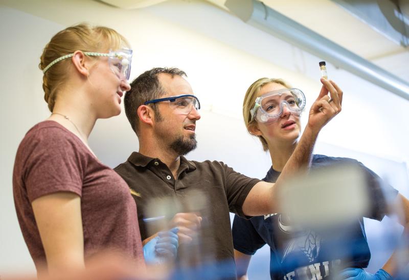 Students work with chemistry professor Stefan Gebbert in class.