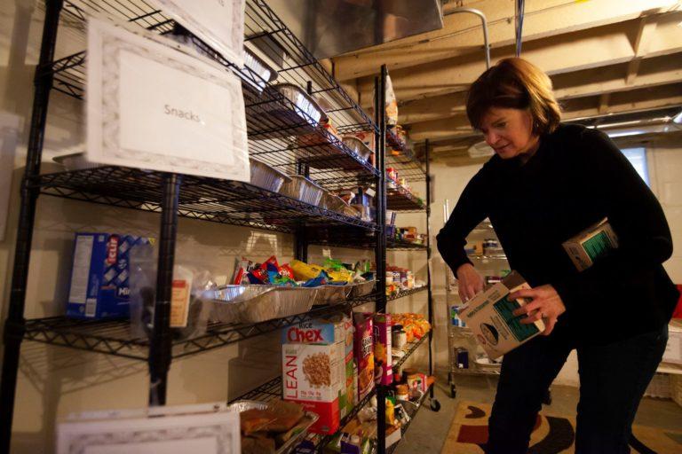 Kate Zoromski, associate dean of academic success, restocks the student food pantry in Sabin House