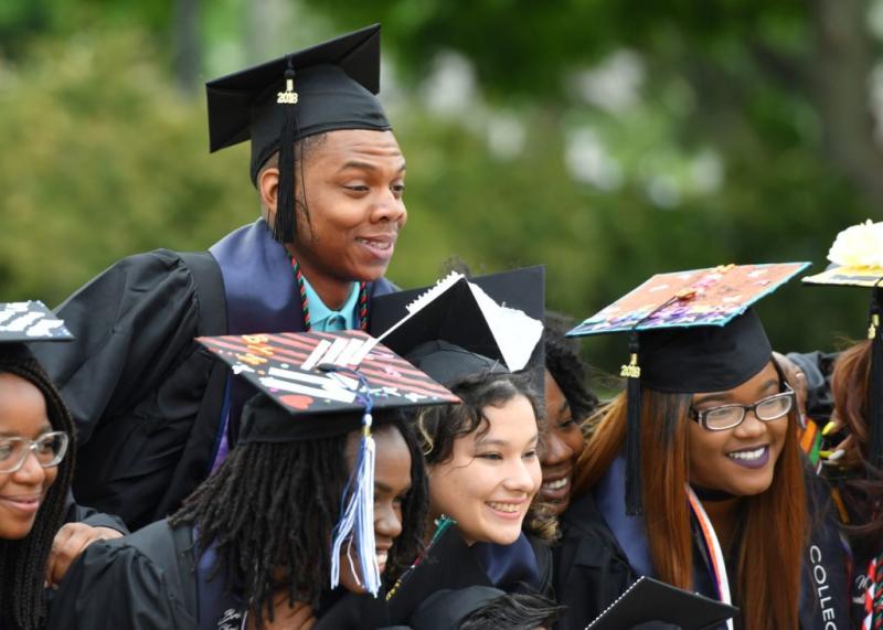 Students posing for pictures at graduation