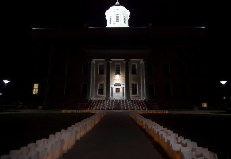 Luminaries line the walkway and steps in front of Main Hall Sunday night. (Photos by Danny Damiani)