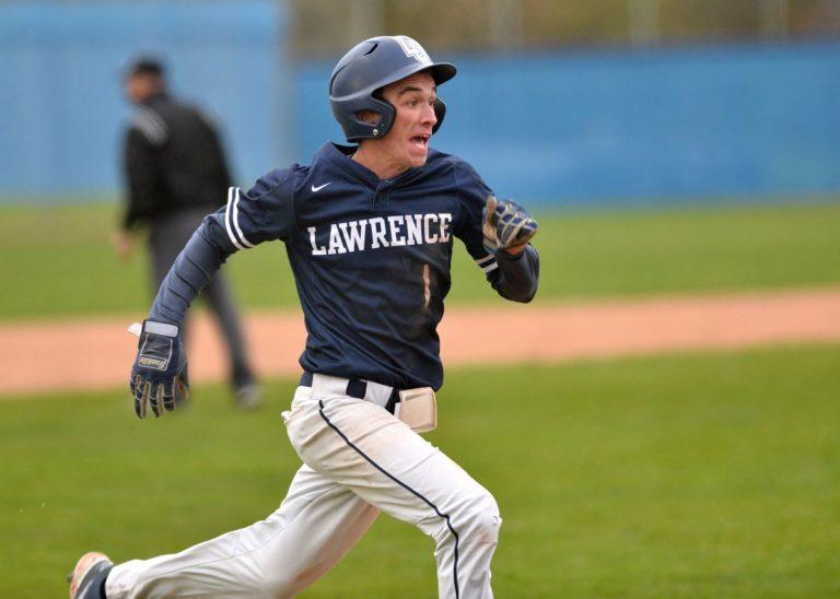 Clayton Agler, wearing a Lawrence baseball uniform, runs toward a base.