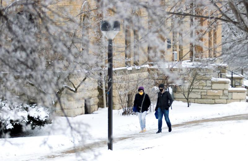 Students walking across the Lawrence campus covered in snow 