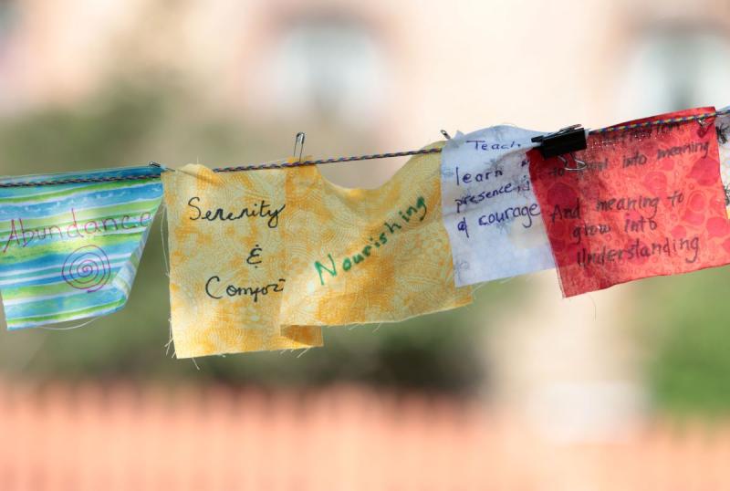 small colorful prayer flags hanging in a cord 