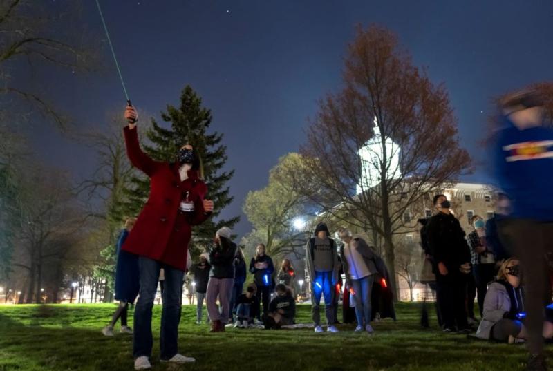 Professor Pickett showing her student the stars at night outside of Main Hall
